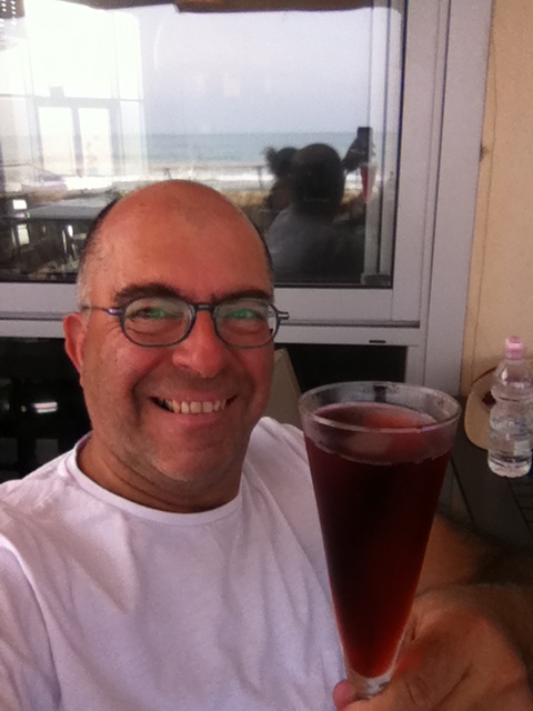 Mel Rosenberg having a drink at the beach