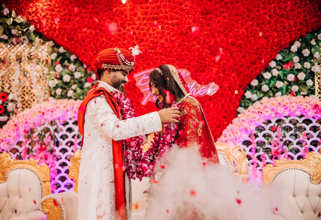 Bride and Groom wearing garland to each other
